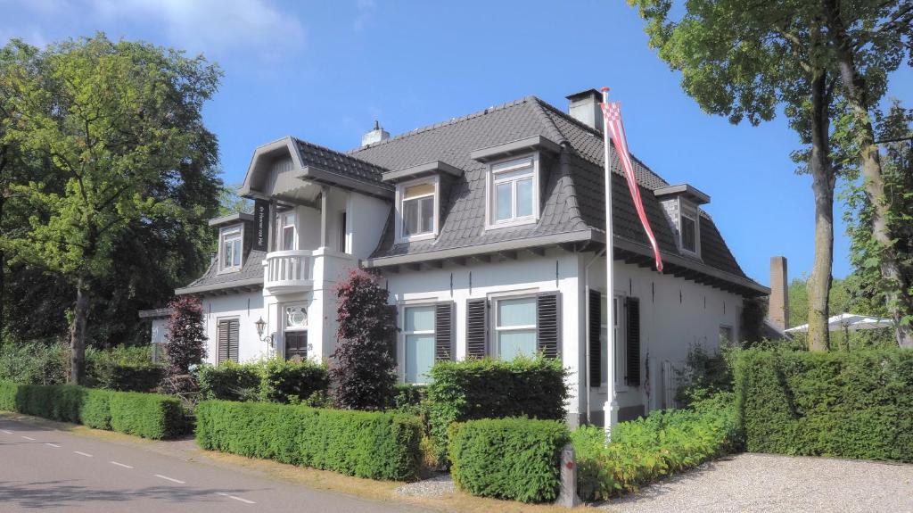 a white house with a gray roof at de Heeren van Hal in Esch