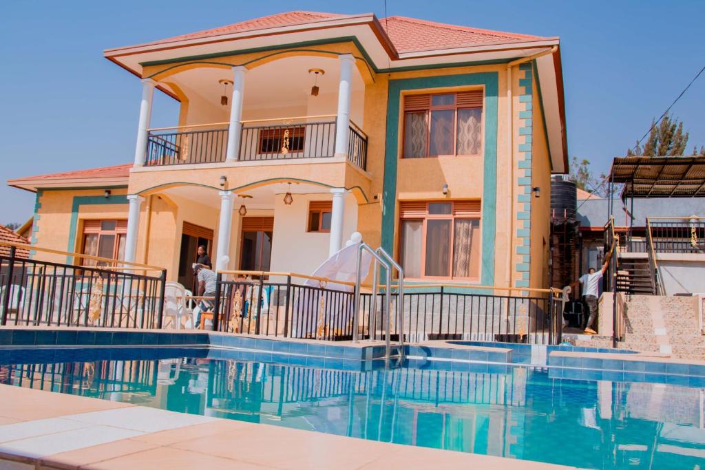 a house with a swimming pool in front of it at SUNFLOWER HOMEs VILLA in Kigali