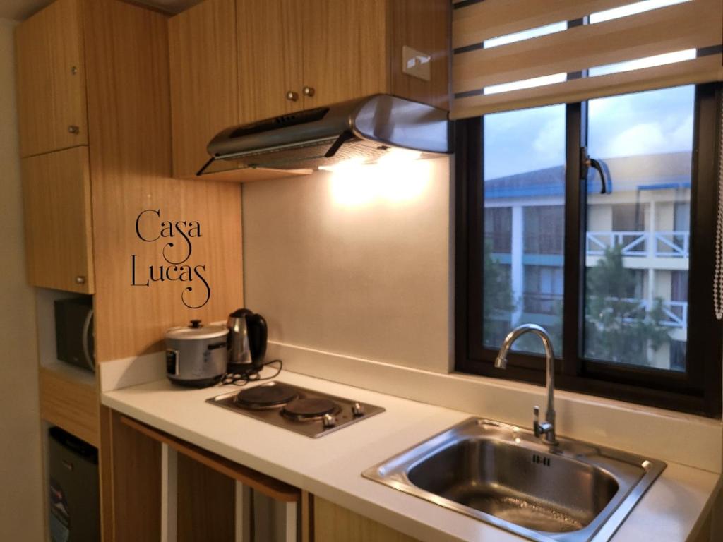 a kitchen with a sink and a window at Casa Lucas in Tagaytay