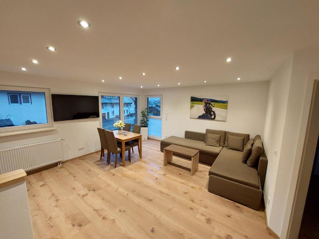 a living room with a couch and a table at Haus an der Haslach in Lenzkirch