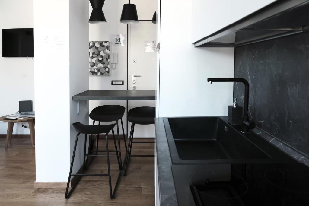a kitchen with a black sink and a counter at ComeCasa Città Studi Terraced Apartment in Milan