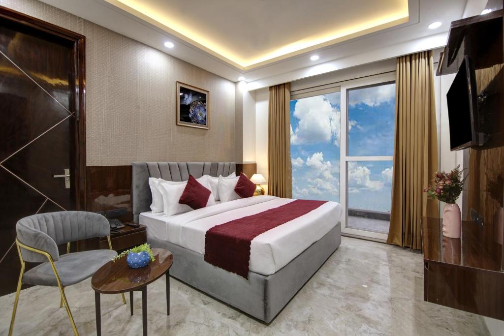 a hotel room with a bed and a large window at Limewood Stay - Millennium Huda city center in Gurgaon