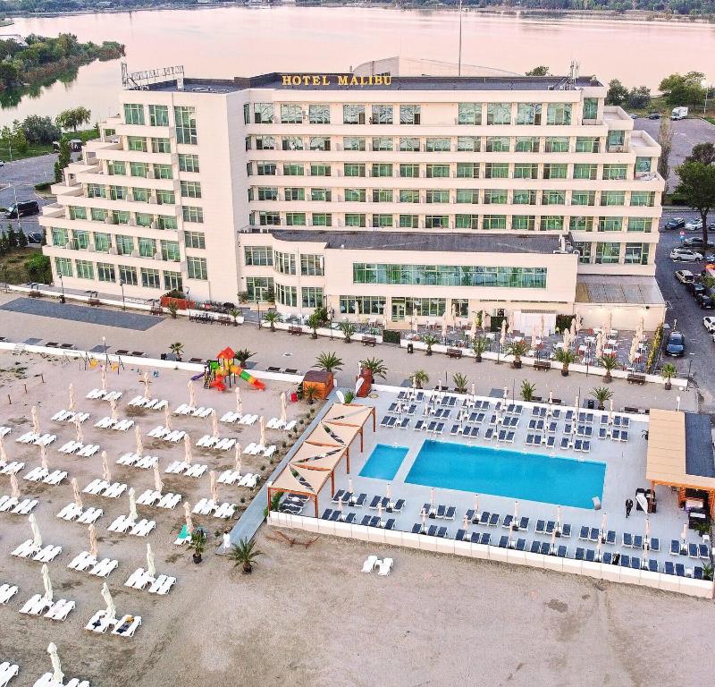 an aerial view of a hotel with chairs and a pool at Hotel Malibu in Mamaia