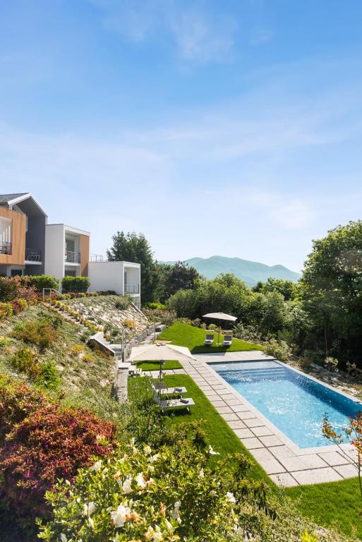 a backyard with a swimming pool and a garden at Residence Conca Verde 1 with pool in Trarego Viggiona