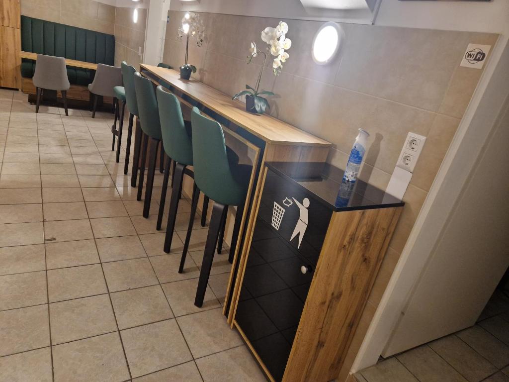 a bar with a row of chairs at a restaurant at Gent Apt in Vienna