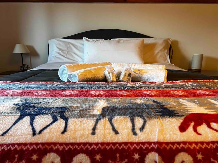 Una cama con una manta de colores encima. en Luxury Apartment on the mountains Wi-fi - Parking, en Tarvisio