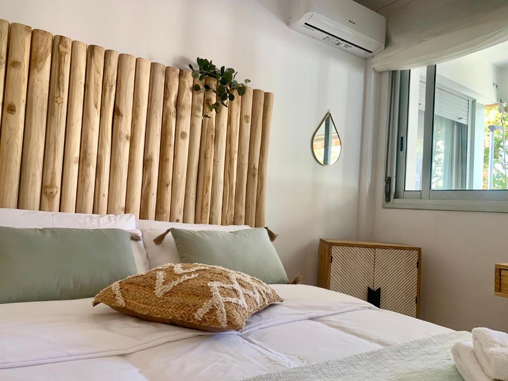 a bed with a pillow on it in a bedroom at Dolce Terrassa 25 min Barcelona and Beach in Terrassa