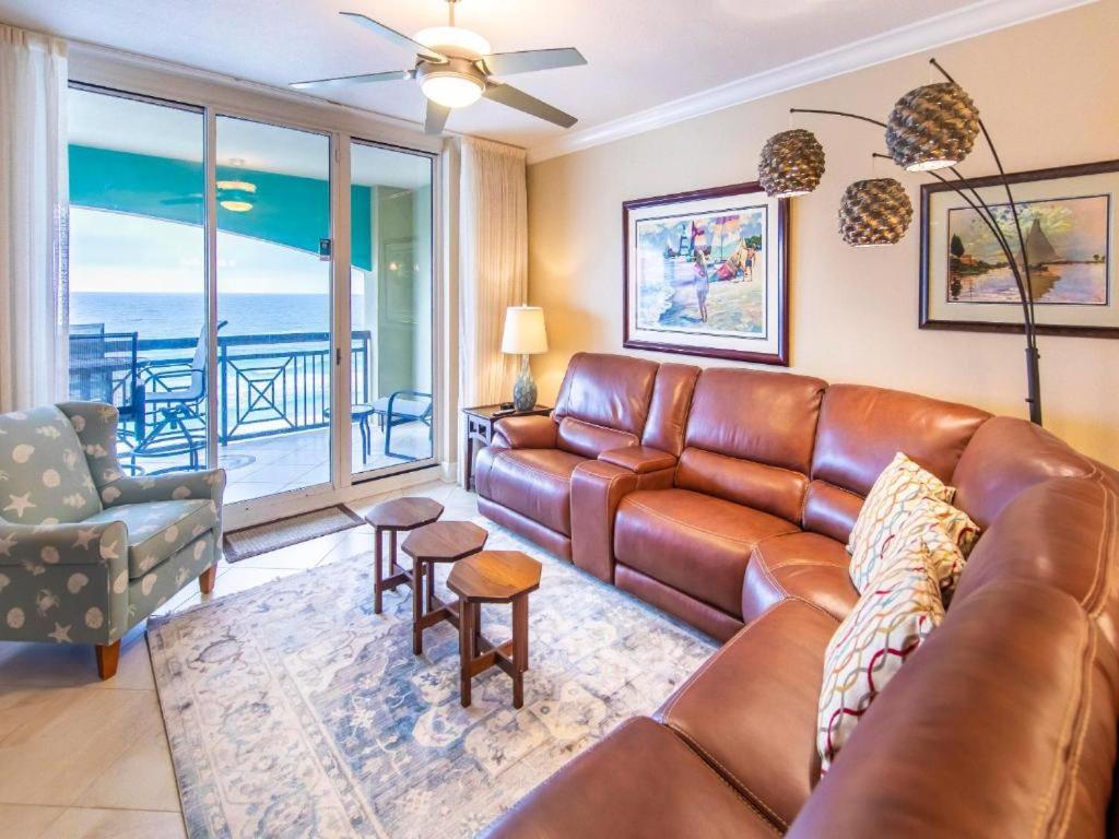a leather couch in a living room with a view of the ocean at Azure #610 - Jack's Beach House - Top Floor Luxury in Fort Walton Beach