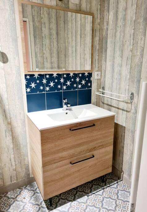 a bathroom with a sink and a mirror at Maison Jean Léone in Gevrey-Chambertin