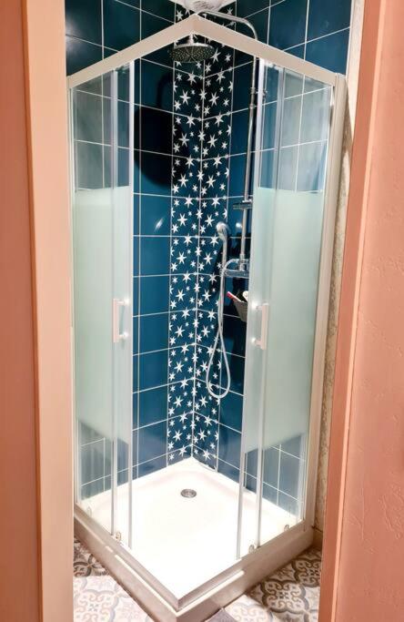 a shower with a glass door in a bathroom at Maison Jean Léone in Gevrey-Chambertin