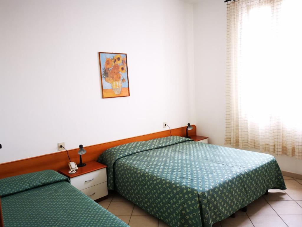 Postel nebo postele na pokoji v ubytování Hotel Rosa