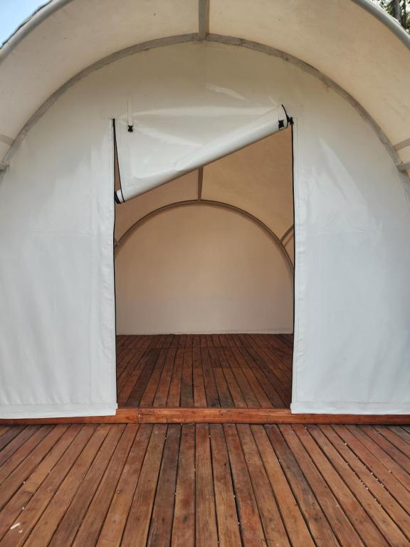a large white tent on a wooden deck at Kayak Glamping in Pondokbungur