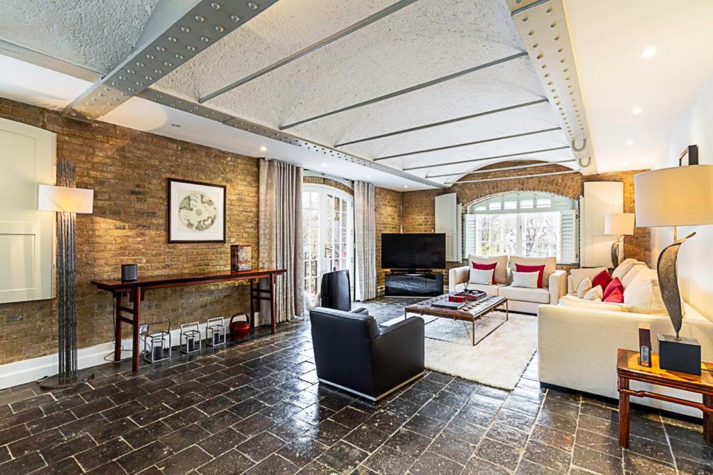 a living room with a couch and a table at Charming Home in St Katharine Docks in London