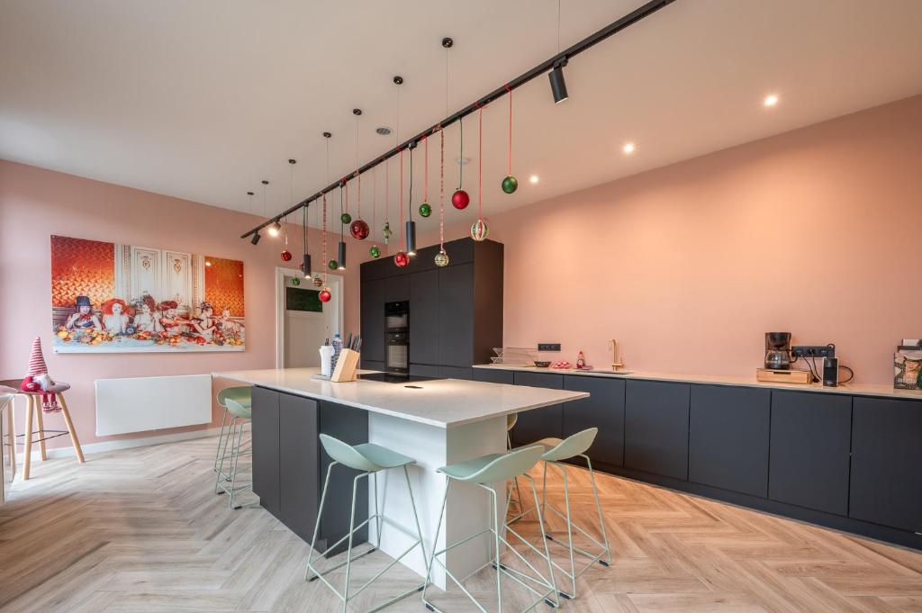 a kitchen with a large island with stools at Villa Cézar - big house at the center of Bruges - free parking in Bruges