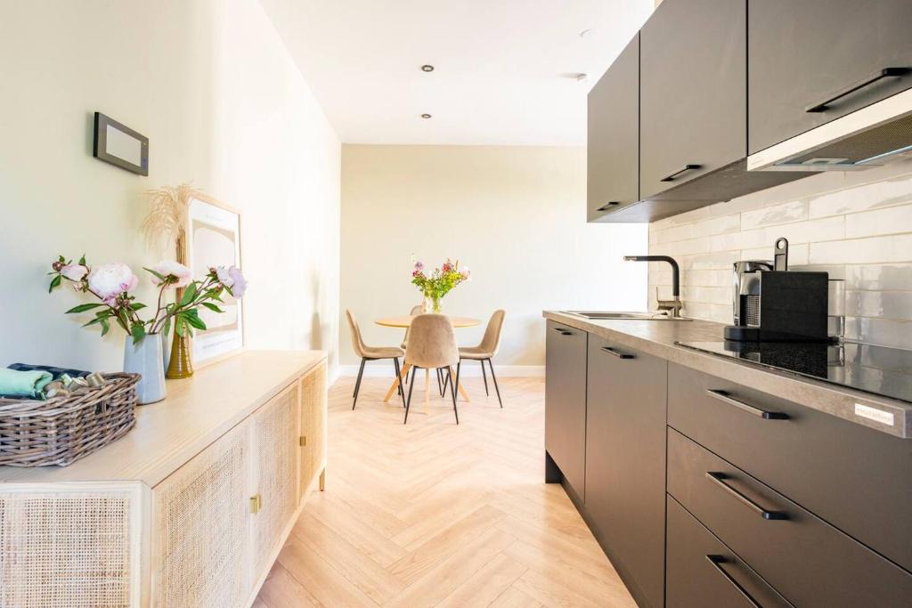 a kitchen with a counter and a table with chairs at Old Town City Centre Apartment 2 in Nijmegen