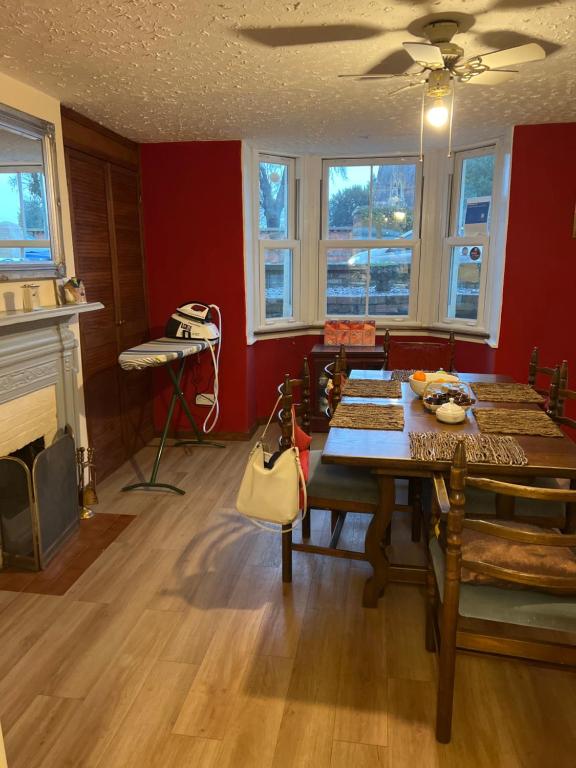 a dining room with a table and a fireplace at The Townhouse B and B in Aylesbury