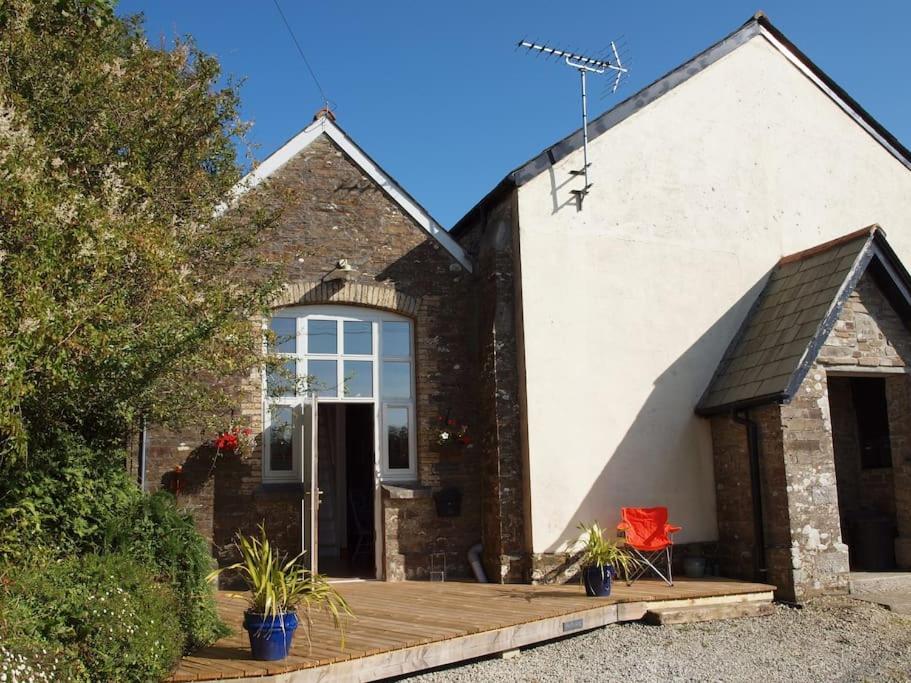 a house with a wooden deck in front of it at Sunday School, Duloe - near Looe, Cornwall, countryside in Liskeard