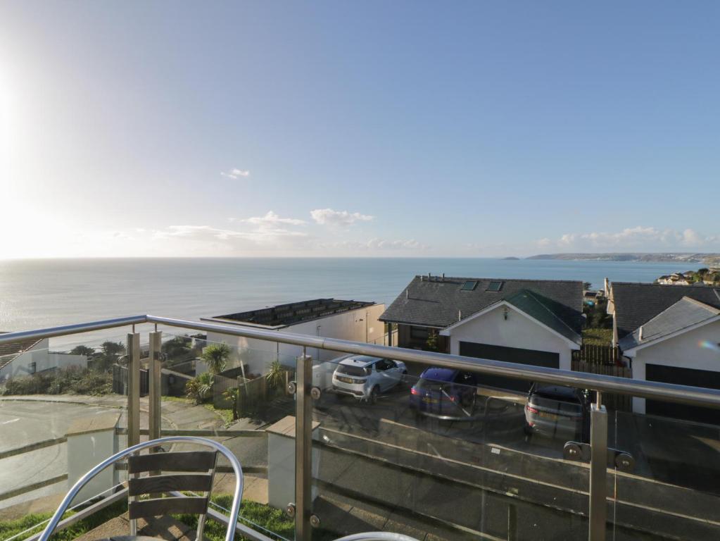 a view of the ocean from the balcony of a house at Looe Island View in Torpoint