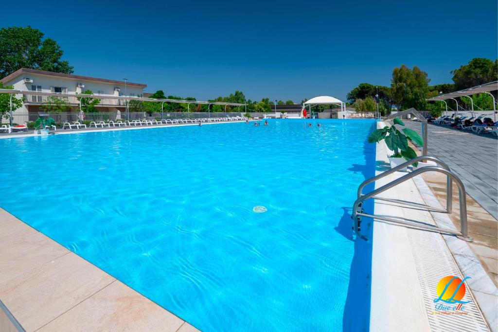 una grande piscina blu con una palla da pallavolo di Village Due Elle a Marina di Schiavonea