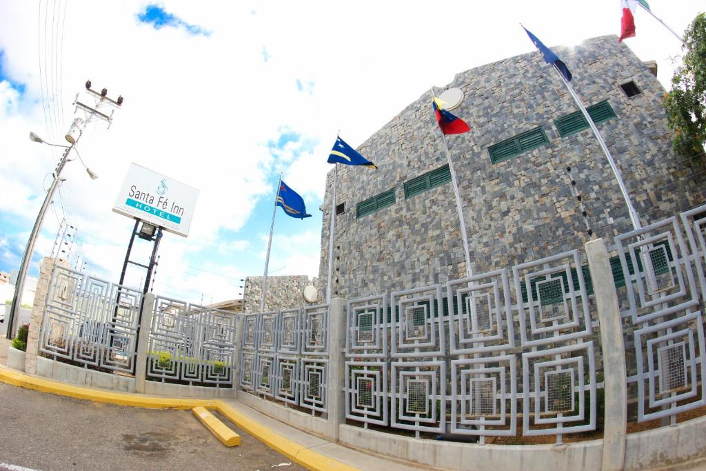 a building with flags on the side of it at Santa Fe Inn Hotel in Punto Fijo