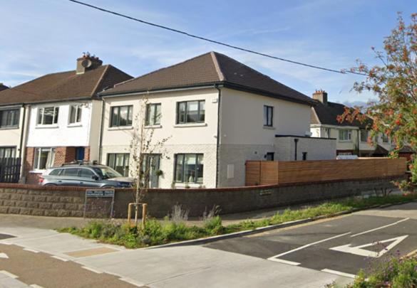 a white house with a car parked in front of it at Stunning Family Home Sleeps 10 in Dublin