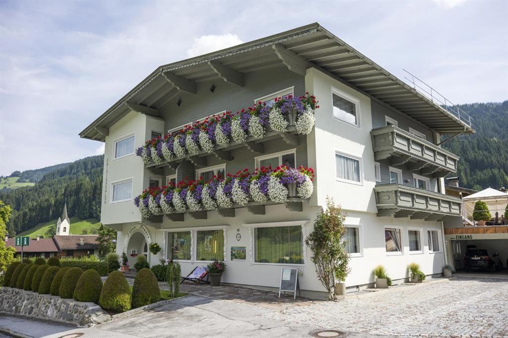 a large white building with flower boxes on it at Appartementhaus Renate Unterer in Kelchsau