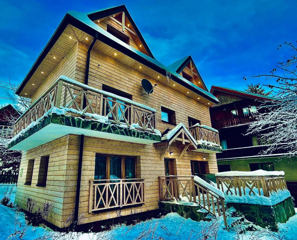 a large building with decks on it in the snow at Villa Corvo Bianco in Sidzina