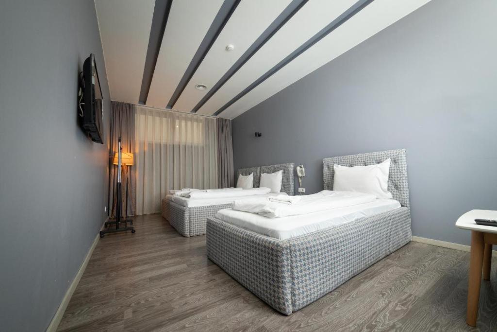 Postel nebo postele na pokoji v ubytování Hotel Gloria KS