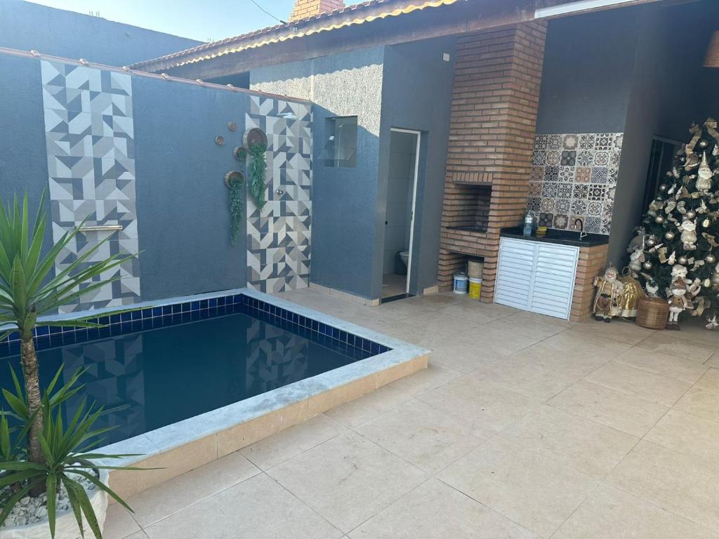 a swimming pool in front of a house at CASA DE PRAIA OLONAN BEACH in Itanhaém