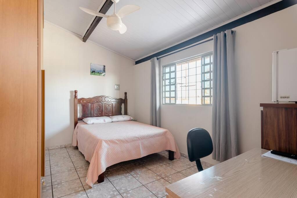 a bedroom with a bed and a window at Suite Vista Panorâmica in Betim