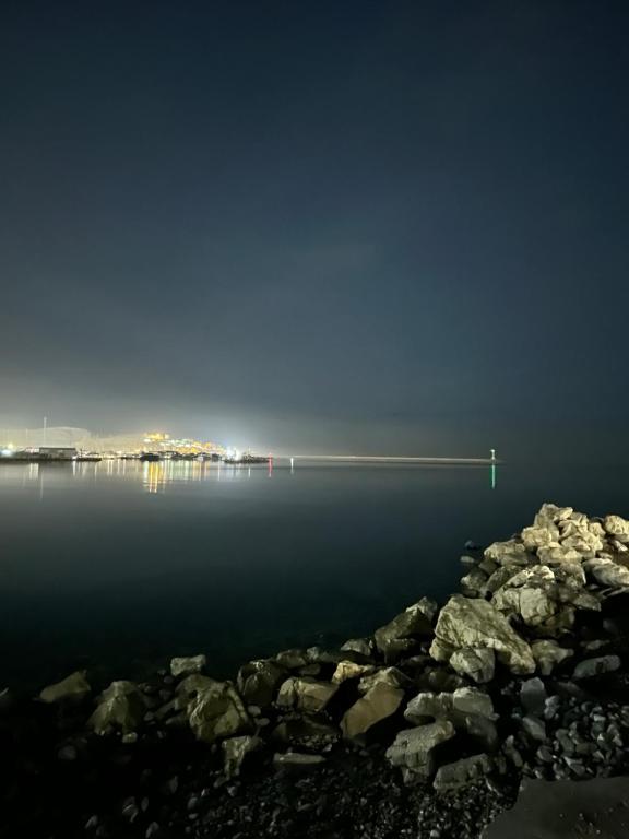 a long dock in the middle of the water at night at Urban Oasis in Šušanj