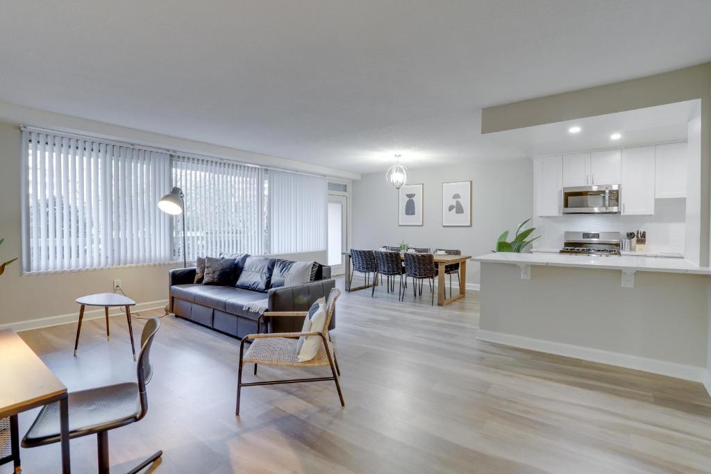 a living room with a couch and a kitchen at Exclusive Airport Proximity: Condo at Crystal City in Arlington