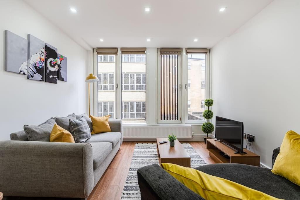 a living room with two couches and a tv at Guest Homes - Maple Court in Ipswich