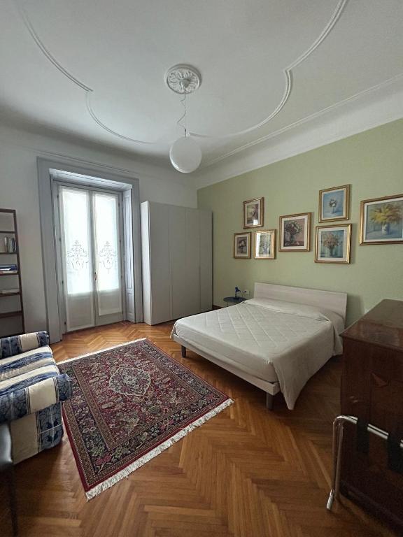 a bedroom with a bed and a rug and a window at Gambara Apartment in Milan