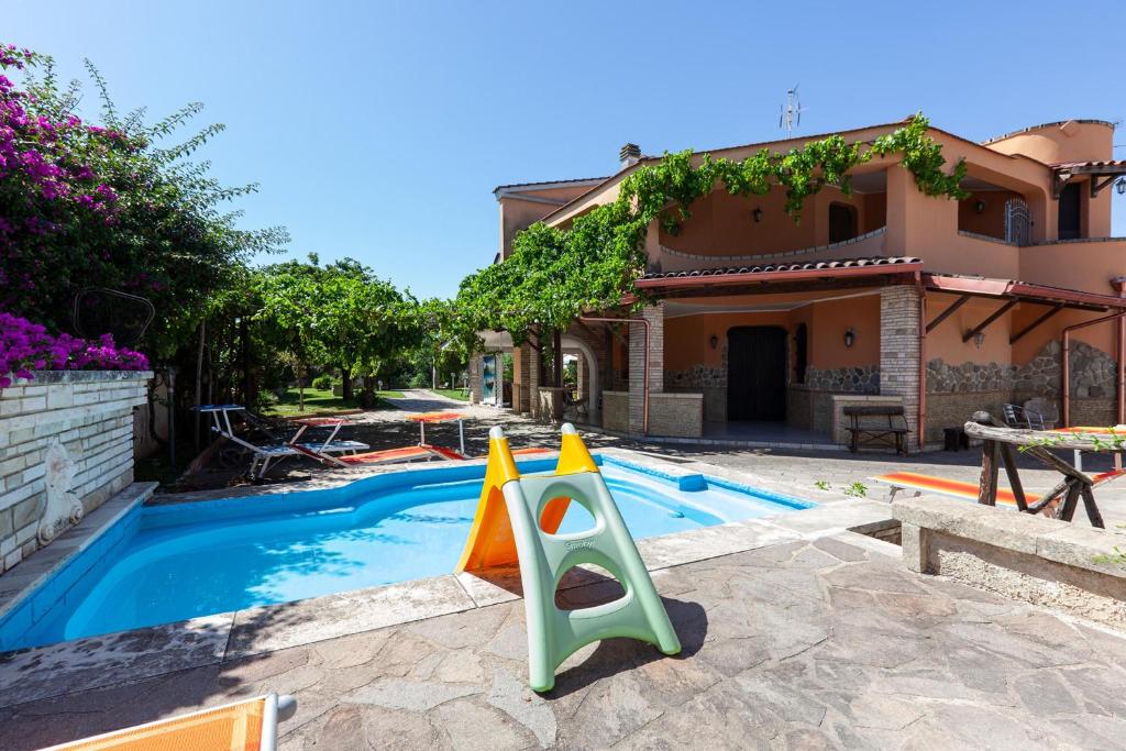 a pool with a plastic slide next to a house at Villa Erika with private pool and garden - Happy Rentals in Lecce