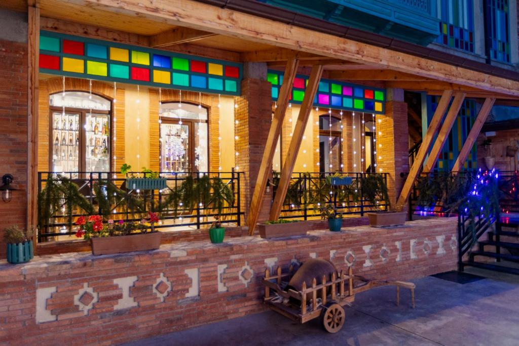 a building with colorful windows and a fence at Dzvel Ubanshi in Gori
