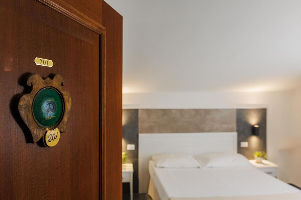 Postel nebo postele na pokoji v ubytování Hotel Le Mura