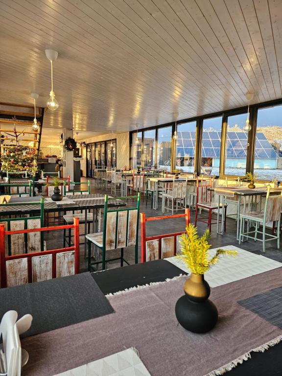 a dining room with tables and chairs and windows at Ursa Mica Glamping Resort in Şirnea