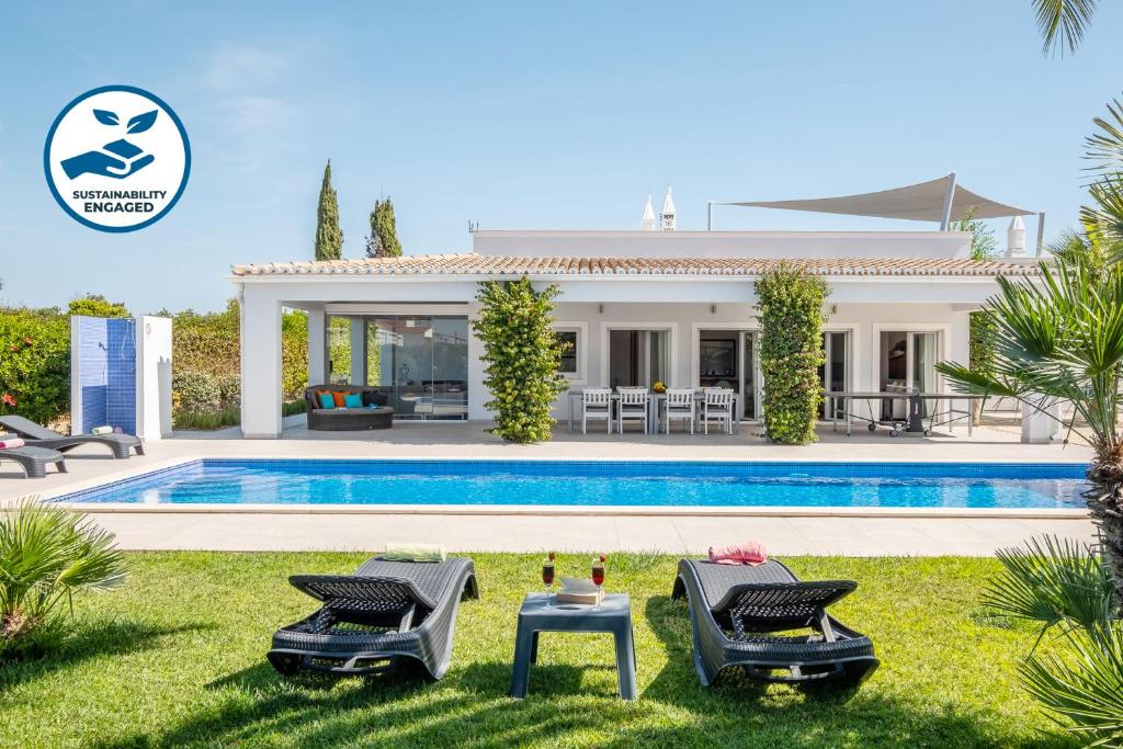 a villa with a swimming pool and a house at Villa Koster by Algarve Vacation in Carvoeiro