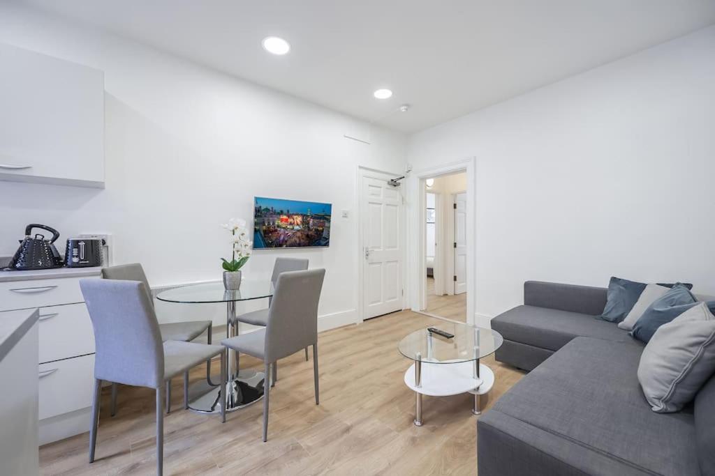 a living room with a couch and a table at 2 Bed Piccadilly Apartment- 3 in London