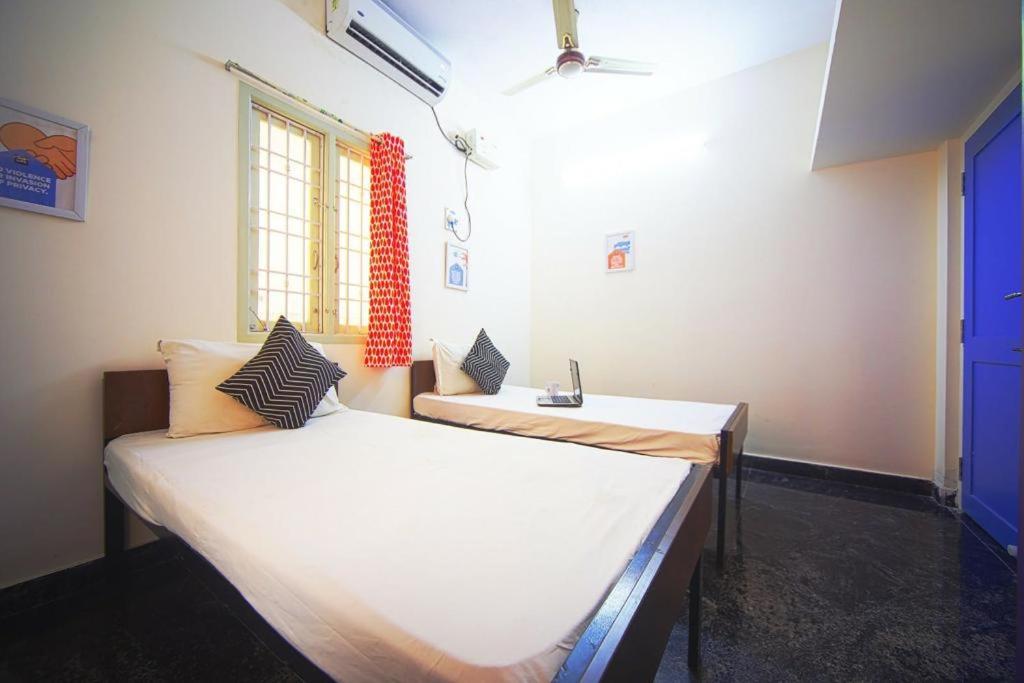 um quarto com duas camas e uma janela em Frankfurt Livings em Chennai