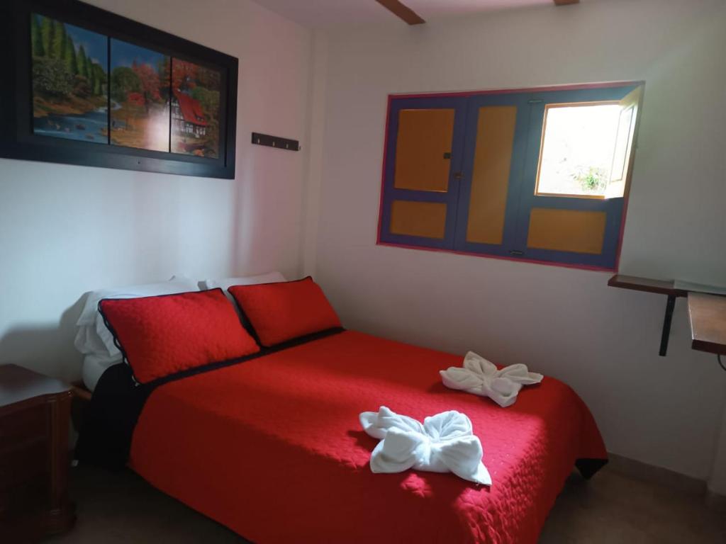 Letto o letti in una camera di Hostal Palmas De Cocora