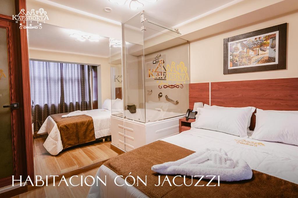 a hotel room with two beds and a shower at Hotel Kapadokya in Huánuco