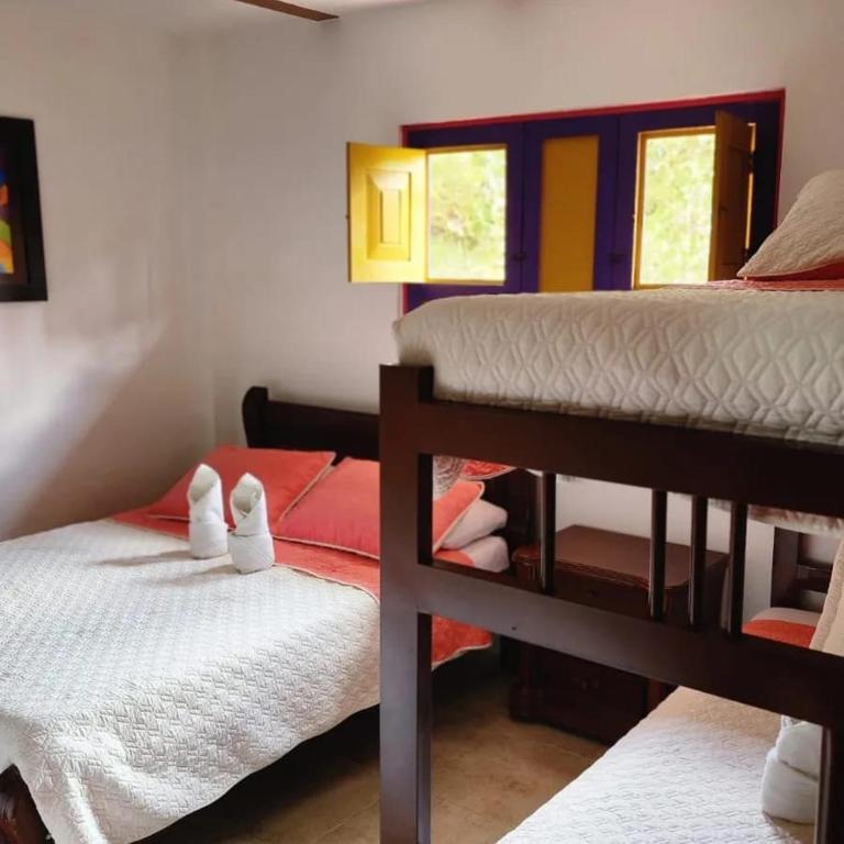 Letto o letti in una camera di Hostal Palmas De Cocora