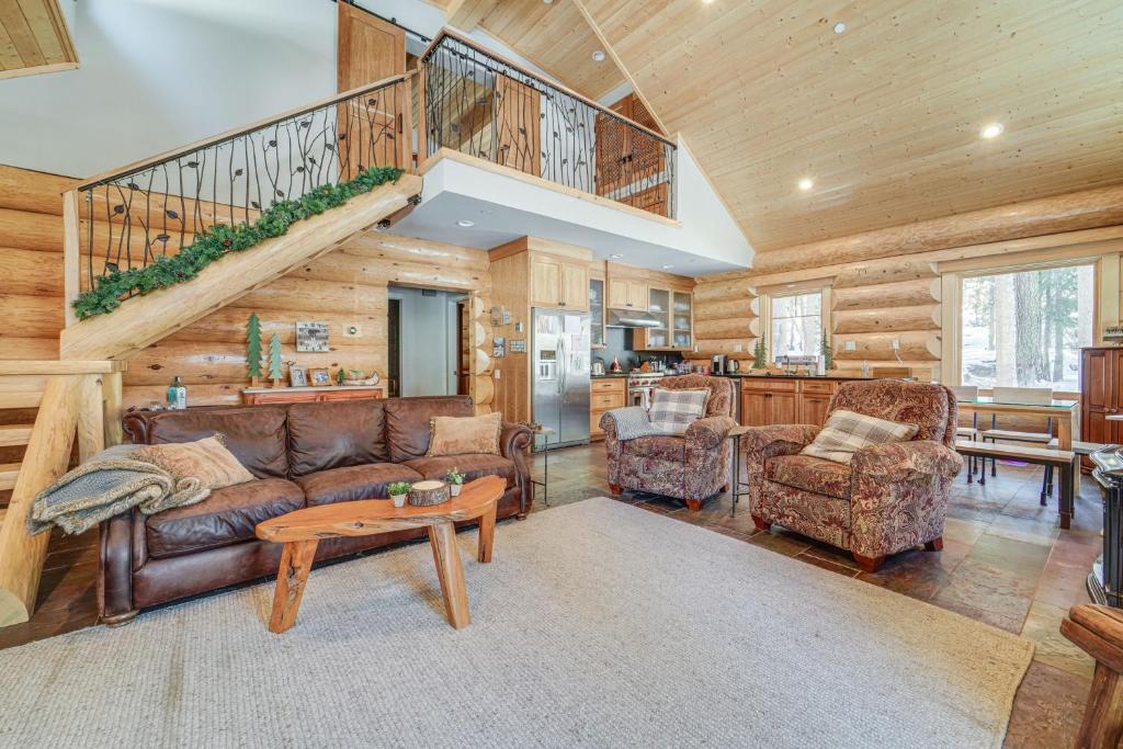 a living room with a couch and a staircase at Truckee Cabin with Patio Less Than 1 Mi to Donner Lake! in Truckee