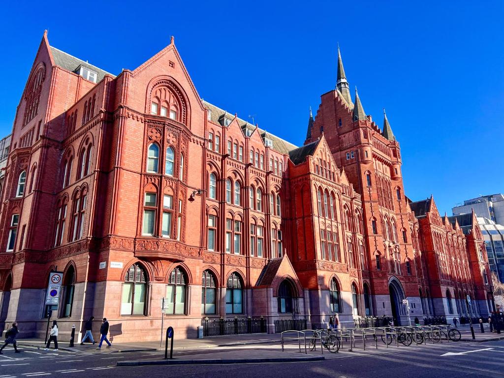 a large red brick building on a city street at Excellent Entire Apartment Between St Pauls Cathedral and Covent Garden in London