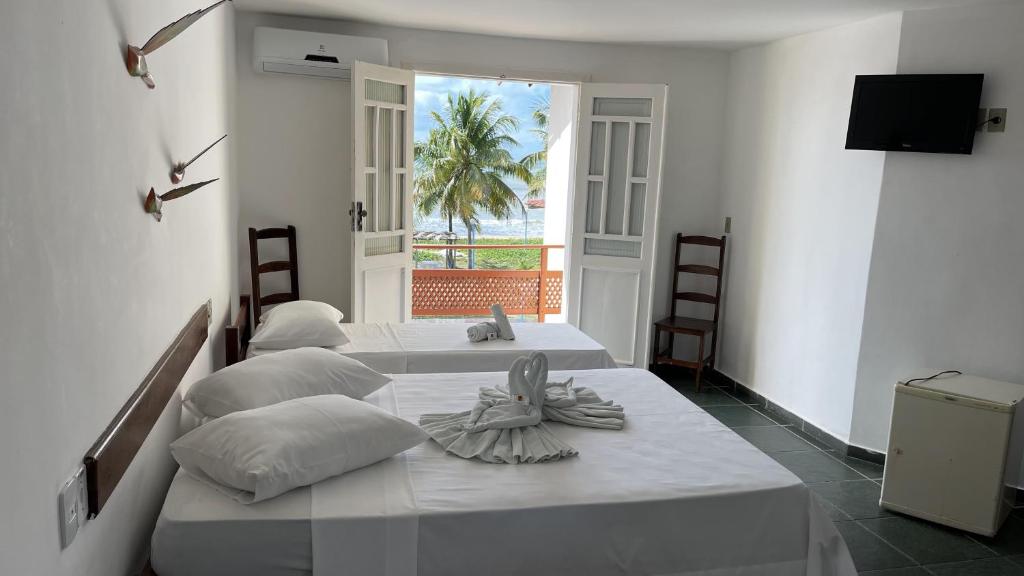 Postel nebo postele na pokoji v ubytování Hotel Brisa dos Abrolhos