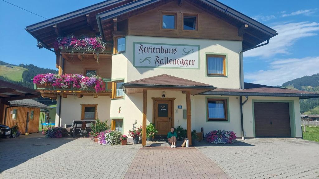a woman standing in front of a building at Ferienhaus Fallenegger in Flachau
