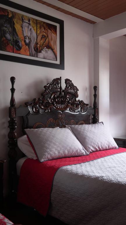 Letto o letti in una camera di Hostal Palmas De Cocora