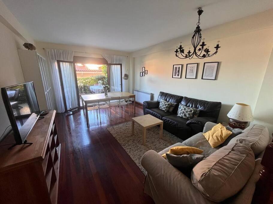 a living room with a couch and a tv at Balcón del Cantábrico in Comillas